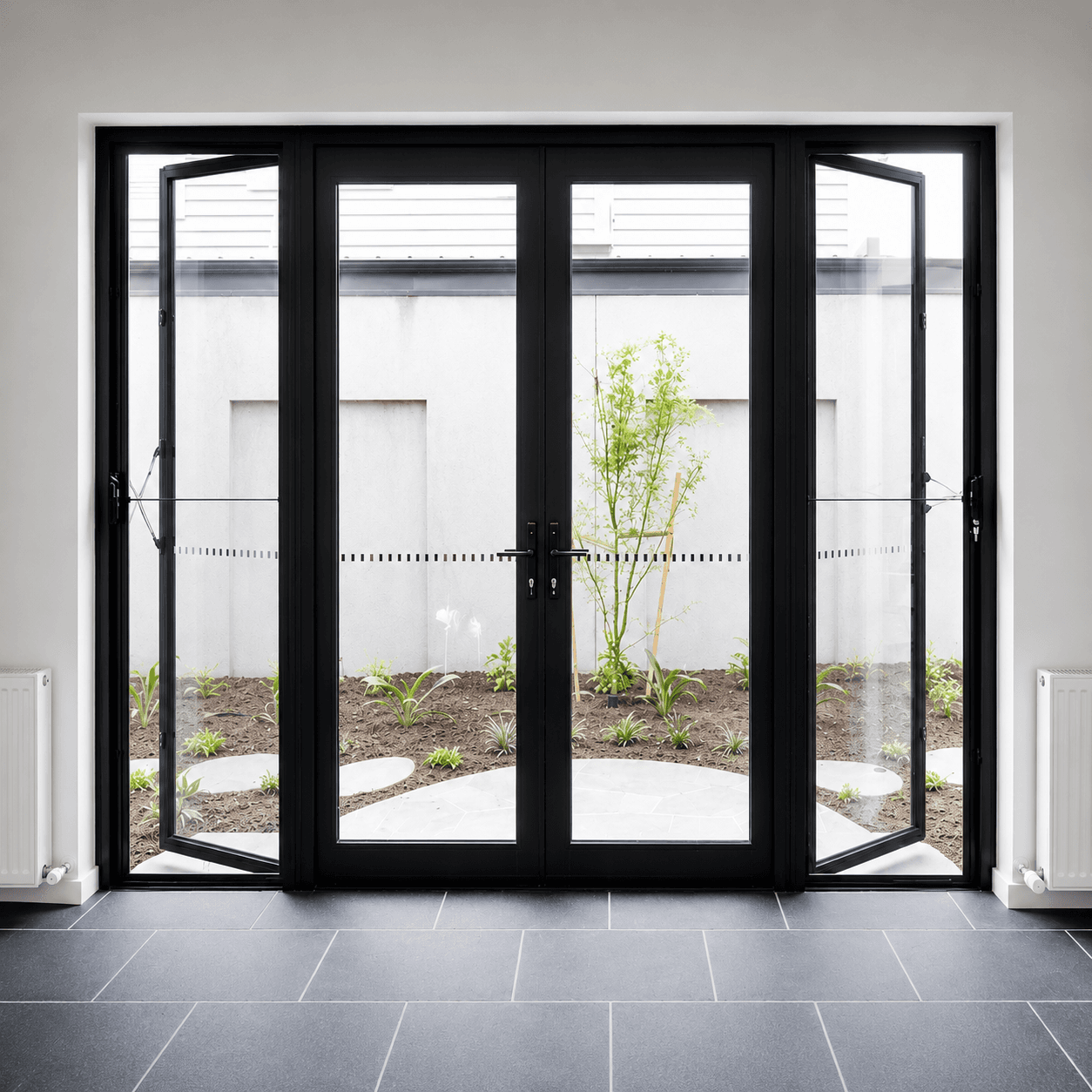 Large black-framed aluminium casement window set into a timber-clad wall